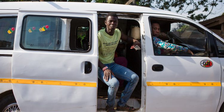 A consumer rides in a trotro to the Medina Market. Trotros are the most popular form of transportation in Ghana allowing consumers to access produce from markets.