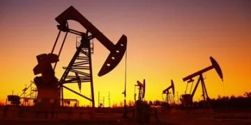 Oil field scene, the evening of beam pumping unit in silhouette