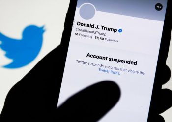 Donald Trump's Twitter account displayed on a phone screen and Twitter logo in the background are seen in this illustration photo taken in Poland on January 9, 2021. Twitter suspended Donald Trump's account because of violating the app rules. (Photo by Jakub Porzycki/NurPhoto via Getty Images)