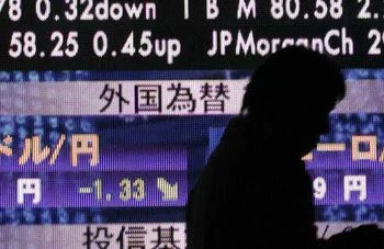 A man walks past a board showing Nikkei stock price index (top) and foreign currency exchange rates outside of a brokerage in Tokyo December 12, 2008. Japanese Finance Minister Shoichi Nakagawa said on Friday that big moves in currency markets were undesirable, adding that he was watching forex market moves with great interest. The dollar tumbled to a 13-year low against the yen on Friday below 90 yen after the U.S. Senate voted down a bailout bill to help U.S. Automakers.     REUTERS/Kim Kyung-Hoon (JAPAN) (Newscom TagID: rtrlthree176412.jpg) [Photo via Newscom]