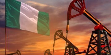 Nigeria oil industry concept, industrial illustration. Nigeria flag and oil wells and the red and blue sunset or sunrise sky background - 3D illustration