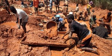 Muddied prospectors pan for gold in Manica Province, near the Zimbabwe border, September 17, 2010. Hundreds of miners work in individual claims rented from local landowners.   REUTERS/Goran Tomasevic  (MOZAMBIQUE - Tags: SOCIETY EMPLOYMENT BUSINESS)