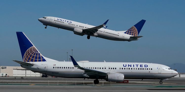 FILE - In this Oct. 15, 2020, file photo, a United Airlines airplane takes off over a plane on the runway at San Francisco International Airport in San Francisco. United Airlines says it will train 5,000 pilots at its own academy in this decade, and it hopes that half of them will be women or people of color. United said Tuesday, April 6, 2021, it is now taking applications for the academy in Arizona, including from people who have no flying experience.  (AP Photo/Jeff Chiu, File)