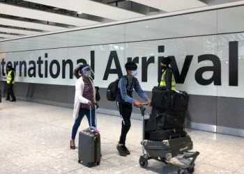 LONDON, ENGLAND - APRIL 23: Passengers are escorted through the arrivals area of terminal 5 towards coaches destined for quarantine hotels, after landing at Heathrow airport on April 23, 2021 in London, England. From 4am this morning, passengers landing in the UK from India are now required to stay in isolation at government-approved hotels for ten days, in a bid to prevent the spread of a new strain of the COVID-19 virus. Indian health services are currently struggling to fight soaring infection rates and a rapidly-rising death toll. (Photo by Leon Neal/Getty Images)