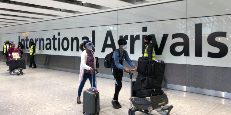 LONDON, ENGLAND - APRIL 23: Passengers are escorted through the arrivals area of terminal 5 towards coaches destined for quarantine hotels, after landing at Heathrow airport on April 23, 2021 in London, England. From 4am this morning, passengers landing in the UK from India are now required to stay in isolation at government-approved hotels for ten days, in a bid to prevent the spread of a new strain of the COVID-19 virus. Indian health services are currently struggling to fight soaring infection rates and a rapidly-rising death toll. (Photo by Leon Neal/Getty Images)