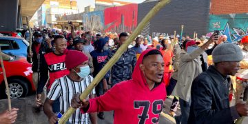 Stick-wielding protesters march through the streets as violence following the jailing of former South African President Jacob Zuma spread to the country's main economic hub in Johannesburg, South Africa, July 11, 2021. REUTERS/ Siphiwe Sibeko
