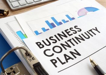 Business continuity plan in a blue folder.