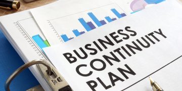 Business continuity plan in a blue folder.