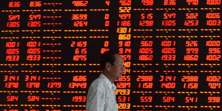 10 Jul 2015, Shenyang, Liaoning Province, China --- (150710) -- SHENYANG, July 10, 2015 (Xinhua) -- An investor walks at a securities firm in Shenyang, northeast China's Liaoning Province, July 10, 2015. Chinese shares staged a two-day strong rebound after intensive moves by the government to bolster the market. The benchmark Shanghai Composite Index leaped 4.54 percent to finish at 3,877.8 points on Friday. The Shenzhen Component Index surged 4.59 percent to close at 12,038.15points. (Xinhua/Pan Yulong) (wf) --- Image by © Pan Yulong/Xinhua Press/Corbis