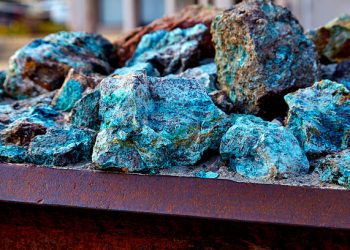 Chunks of copper ore mineral rocks in an iron barrel