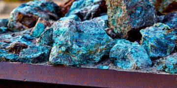 Chunks of copper ore mineral rocks in an iron barrel
