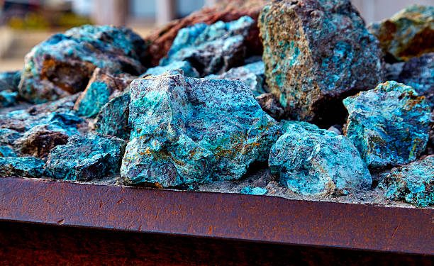 Chunks of copper ore mineral rocks in an iron barrel