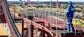 Kuruman, South Africa - April 20, 2012: Conveyor Belt transporting raw manganese ore rocks at Open Pit Manganese Mine