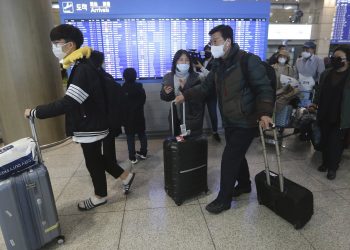 South Koreans tourists return from Israel at Incheon International Airport in Incheon, South Korea, Tuesday, Feb. 25, 2020. South Korean tourists returned home from Israel on Tuesday after the Israeli government imposed entry ban on South Koreans over concerns about new coronavirus. (AP Photo/Ahn Young-joon)