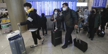 South Koreans tourists return from Israel at Incheon International Airport in Incheon, South Korea, Tuesday, Feb. 25, 2020. South Korean tourists returned home from Israel on Tuesday after the Israeli government imposed entry ban on South Koreans over concerns about new coronavirus. (AP Photo/Ahn Young-joon)