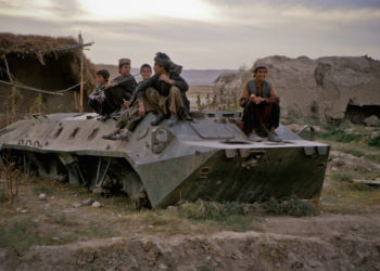 Children playing on an old military tank in Afghanistan.