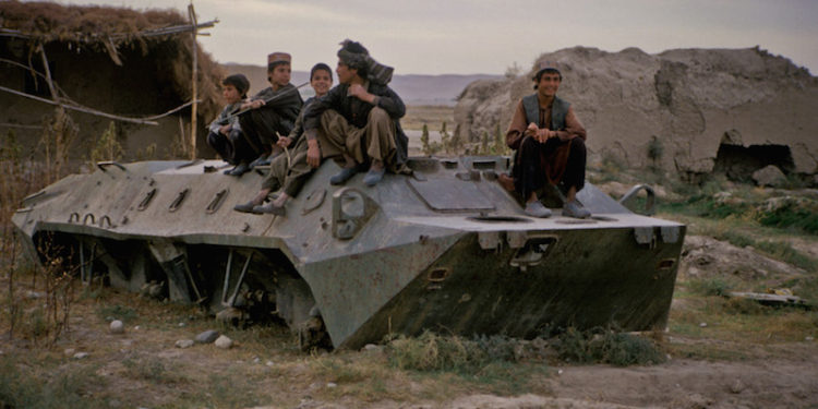 Children playing on an old military tank in Afghanistan.