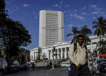 A pedestrian walks past the Reseve Bank of India (RBI) in Mumbai, India, on Monday, March. 9, 2020. A top Indian official said there's no need for the government to take immediate steps to support the economy following a crash in oil prices that has sent financial markets into a tailspin. Photographer: Dhiraj Singh/Bloomberg via Getty Images