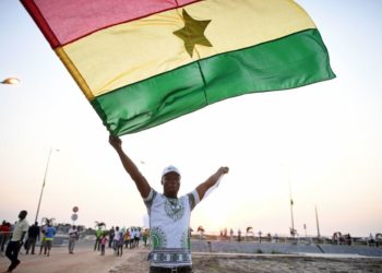 A Ghana supporter waves a Ghanaian flag as he arrives to attend the 2017 Africa Cup of Nations group D football match between Egypt and Ghana in Port-Gentil on January 25, 2017. (Photo by Justin TALLIS / AFP) (Photo by JUSTIN TALLIS/AFP via Getty Images)