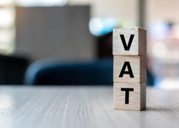 wooden cube with VAT text on table background. Financial, marketing and business concepts