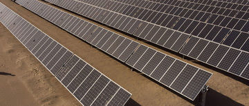 A worker checks that the solar panels are working properly. The Sonnedix photovoltaic plant, contains about half a million solar panels that produce 470Gwh of clean electricity per year, connecting to the substation of the Lagunas National Electric System. It is 46kms long and is located in the Atacama Desert, the driest desert in the world, which has the highest levels of (direct) solar radiation on the planet. The operation of this photovoltaic plant generates energy capable of supplying 100,000 homes. In addition, its operation avoids the annual emission of 200 thousand tons of CO2. IMF Photo/Tamara Merino23 June 2021Pica, ChilePhoto ref: 090_Tamara Merino.jpg