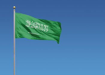 Flag of Saudi Arabia in front of a clear blue sky
