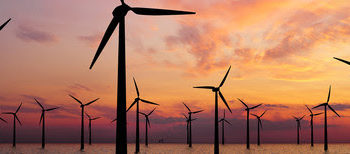 Offshore Wind Turbines Farm At sunset
