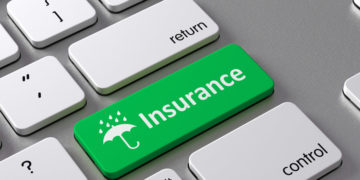 A keyboard with a green button Insurance