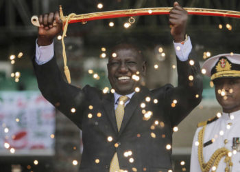 Kenya's new president William Ruto, seen behind fountain fireworks, holds up a ceremonial sword as he is sworn in to office at a ceremony held at Kasarani stadium in Nairobi, Kenya Tuesday, Sept. 13, 2022. William Ruto was sworn in as Kenya's president on Tuesday after narrowly winning the Aug. 9 election and after the Supreme Court last week rejected a challenge to the official results by losing candidate Raila Odinga. (AP Photo/Brian Inganga)