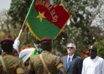 Minister of Defense and Veteran affairs, Chèrif Sy, U.S. Ambassador to Burkina Faso, Andrew Young, render honors during a pass and review portion of the closing ceremony to Flintlock 2019.  This year’s exercise is being hosted by U.S. African partner nation Burkina Faso.  By bringing members of the G5 Sahel, Multinational Joint Task Force, and various troop contributing nations together to develop and implement complimentary tactical operations, Flintlock 2019 better enables African partners to conduct real world missions structured around a coherent campaign plan. (U.S. Navy photo by MC2 (SW/AW) Evan Parker / released)