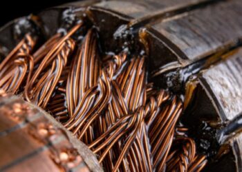 Copper electric motor winding. Electric mechanism rotor. Dark background.