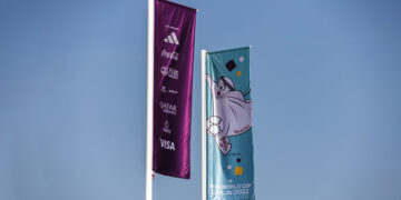 Sponsor logos on display on a flag outside Lusail Stadium in Doha, Qatar, on Saturday, Nov. 19, 2022. Embattled FIFA President Gianni Infantino pushed back against criticism of the Qatar World Cup a day before the tournament begins following years of planning. Photographer: Christopher Pike/Bloomberg