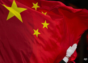 A Chinese flag is raised during a medal ceremony for the women's freestyle skiing big air at the 2022 Winter Olympics, Tuesday, Feb. 8, 2022, in Beijing. (AP Photo/Jae C. Hong)