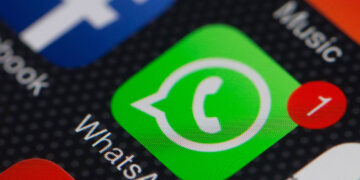 The WhatsApp Inc. mobile-messaging application WhatsApp and the Facebook Inc. application are displayed along with other apps on an Apple Inc. iPhone in this arranged photograph taken in Hong Kong, China, on Thursday, Feb. 20, 2014. Facebook, the worlds largest social network, agreed to acquire mobile-messaging startup WhatsApp Inc. for as much as $19 billion in cash and stock, seeking to expand its reach among users on mobile devices. Photographer: Bloomberg/Bloomberg