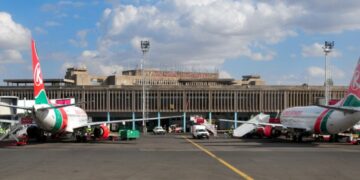 Nairobi, Kenya - August 24, 2008: Kenya Airways aircraft at the terminal building of Jomo Kenyatta International Airport