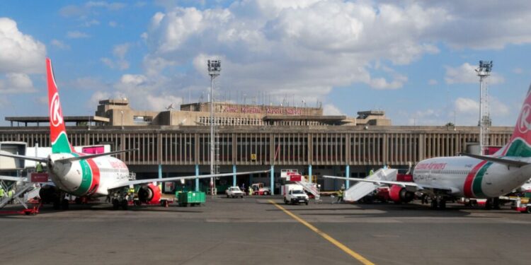 Nairobi, Kenya - August 24, 2008: Kenya Airways aircraft at the terminal building of Jomo Kenyatta International Airport