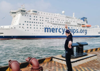 Jim Paterson, Marine Executive Consultant, waving the Global Mercy away as she sails from shipyard in Tianjin, China.