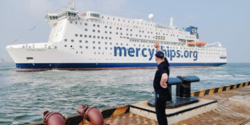 Jim Paterson, Marine Executive Consultant, waving the Global Mercy away as she sails from shipyard in Tianjin, China.