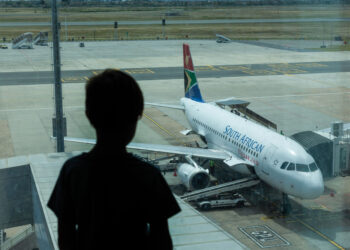 A South African Airways (SAA) parked at the gate at Cape Town International Airport in Cape Town, South Africa, on Friday, Dec. 3, 2021. South Africa announced the discovery of a new variant, later named omicron, on Nov. 25 as cases began to spike and the strain spread across the globe, with many countries halting flights to and from southern Africa. Photographer: Dwayne Senior/Bloomberg