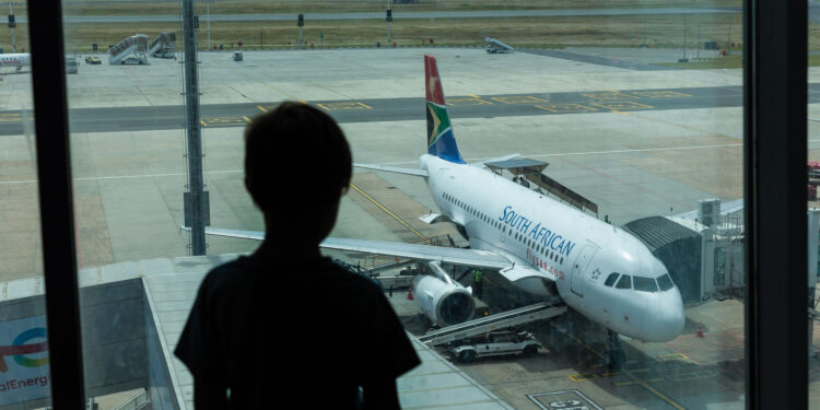 A South African Airways (SAA) parked at the gate at Cape Town International Airport in Cape Town, South Africa, on Friday, Dec. 3, 2021. South Africa announced the discovery of a new variant, later named omicron, on Nov. 25 as cases began to spike and the strain spread across the globe, with many countries halting flights to and from southern Africa. Photographer: Dwayne Senior/Bloomberg