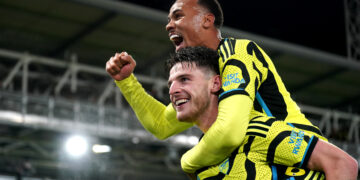 Arsenal's Declan Rice (bottom) and Gabriel celebrate victory after the final whistle in the Premier League match at Kenilworth Road, Luton. Picture date: Tuesday December 5, 2023. (Photo by Joe Giddens/PA Images via Getty Images)