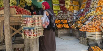 An Egyptian woman shops at a fruit market in Cairo, on March 17, 2022. - Soaring bread prices sparked by Russia's invasion of Ukraine have bitten into the purchasing power of consumers in Egypt, a leading importer of wheat from the former Soviet states. (Photo by Khaled DESOUKI / AFP) (Photo by KHALED DESOUKI/AFP via Getty Images)