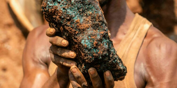 Dela wa Monga, an artisanal miner, holds a cobalt stone at the Shabara artisanal mine near Kolwezi on October 12, 2022. - Some 20,000 people work at Shabara, in shifts of 5,000 at a time.
Congo produced 72 percent of the worlds cobalt last year, according to Darton Commodities. And demand for the metal is exploding due to its use in the rechargeable batteries that power mobile phones and electric cars.
But the countrys poorly regulated artisanal mines, which produce a small but not-negligeable percentage of its total output, have tarnished the image of Congolese cobalt. (Photo by Junior KANNAH / AFP) (Photo by JUNIOR KANNAH/AFP via Getty Images)