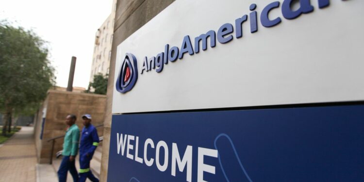 Visitors pass a sign at the entrance to the offices of Anglo American Plc in the Marshalltown district of Johannesburg, South Africa, on Friday, Oct. 26, 2012. Anglo American Plc Chief Executive Officer Cynthia Carroll , the first woman, external hire and non-South African to hold the job, will quit after Anglo lost $14 billion in value in the more than five years she was in charge. Photographer: Chris Ratcliffe/Bloomberg via Getty Images