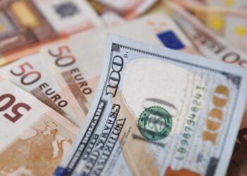 A $100-dollar bill is seen on top of Euro bills in Bogota, on July 12, 2022. - The euro struck parity with the dollar for the first time in nearly 20 years on Tuesday as a cut in Russian gas supplies to Europe heightened fears of a recession in the eurozone. (Photo by DANIEL MUNOZ / AFP) (Photo by DANIEL MUNOZ/AFP via Getty Images)
