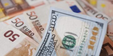 A $100-dollar bill is seen on top of Euro bills in Bogota, on July 12, 2022. - The euro struck parity with the dollar for the first time in nearly 20 years on Tuesday as a cut in Russian gas supplies to Europe heightened fears of a recession in the eurozone. (Photo by DANIEL MUNOZ / AFP) (Photo by DANIEL MUNOZ/AFP via Getty Images)