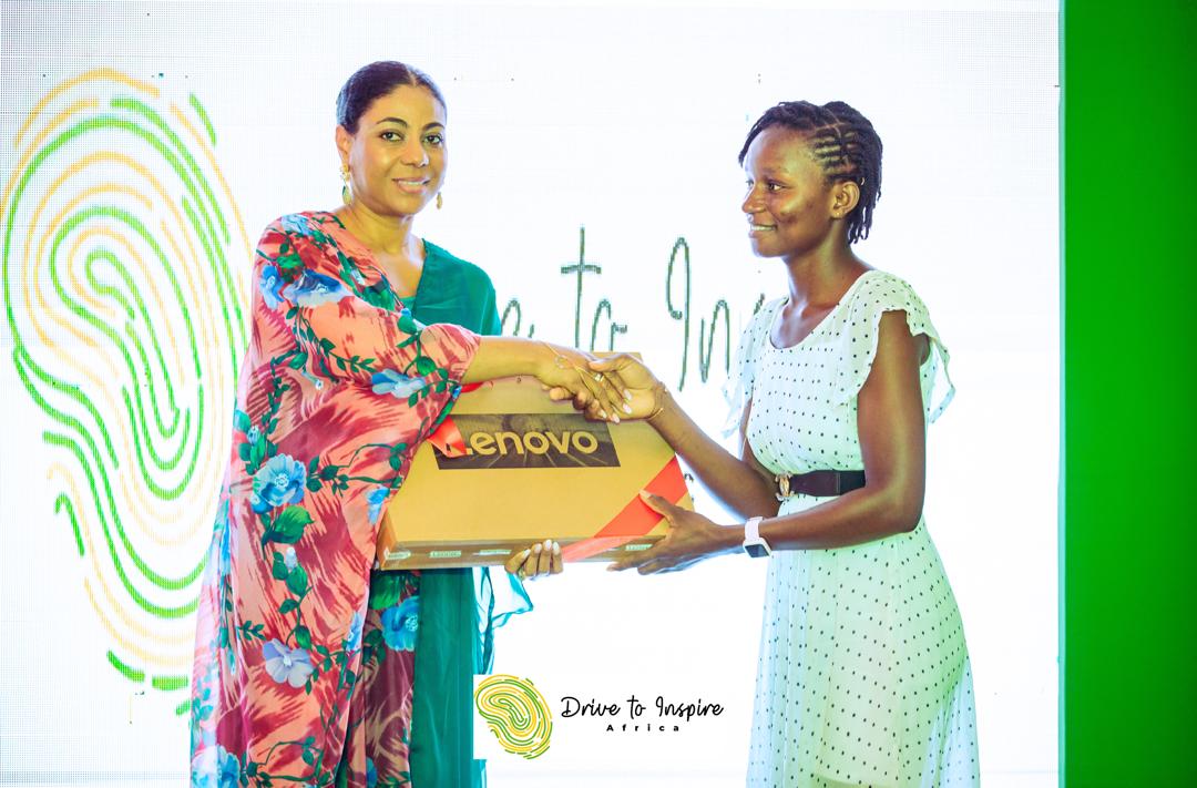 A student recipient receiving a laptop from Ms Angela List, CEO of Adamus Mining Ltd