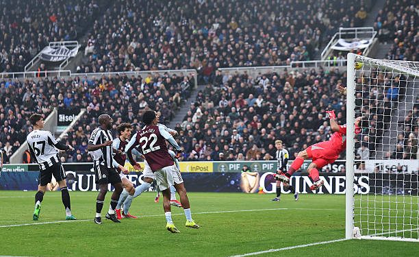 NEWCASTLE UPON TYNE, ENGLAND - JANUARY 25:  Emiliano Martinez of Aston Villa saves from Lewis Miley of Newcastle United during the Premier League match between Newcastle United and Aston Villa at St James' Park on January 25, 2026 in Newcastle upon Tyne, England. (Photo by Robbie Jay Barratt - AMA/Getty Images)